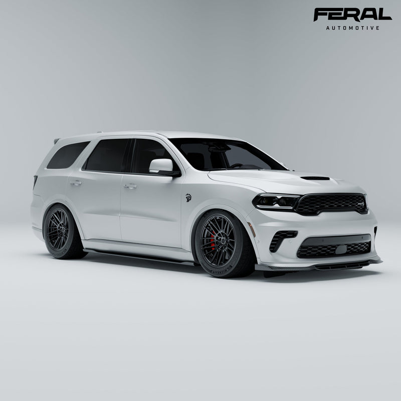 White Dodge Durango SRT Hellcat with the Feral carbon front spoiler and side skirts, front three-quarter view