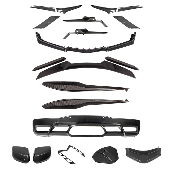 Carbon fiber C8 Corvette Coupe exterior kit parts laid out, shown with the Z06 center-exit diffuser